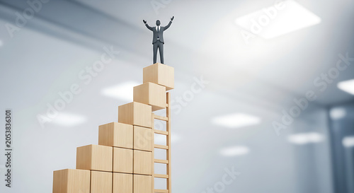 Businessman reaches the highest point of a wooden ladder built upon stacked cubes for success growth.