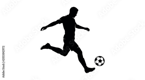 Silhouette of a soccer player kicking a ball in mid action