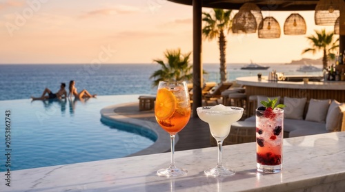 Refreshing cocktails served beside an infinity pool overlooking a tropical seaside setting