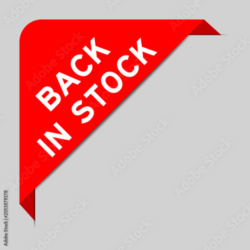 Canvas Print Red color of corner label banner with word back in stock on gray background