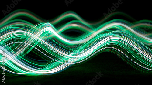 Abstract flowing green and white light trails on a dark background with dynamic motion