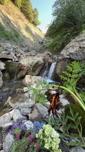 Peaceful Forest Stream with Small Waterfalls and Teapot on Campfire