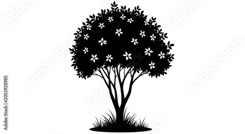 Silhouette of a flowering tree with grass at its base in black and white.