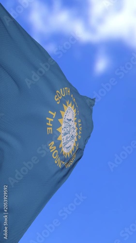 South Dakota State Flag Waving Against Bright Blue Sky