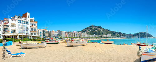 Panoramic view of sandy beach with fishing boats in Blanes town. Costa Brava, Catalonia, Spain