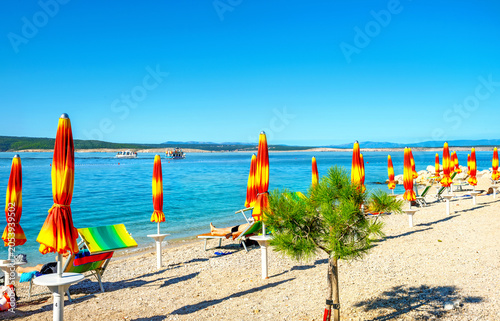 Seascape with colorful umbrellas on the beach in Crikvenica town. Kvarner bay, Croatia