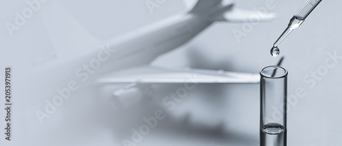 Pipette dropping liquid into a test tube with a blurred airplane in the background, symbolizing the transport of medical supplies, medicine, and vaccines.