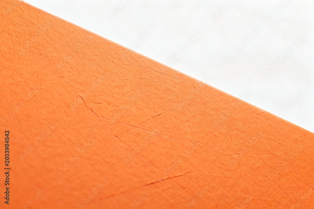 Fototapeta premium Close-up of Orange Paper Texture with Cracks