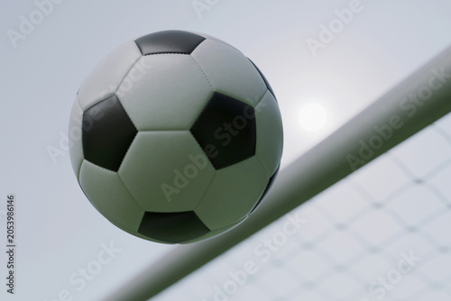 Fényképezés Close-up of a soccer ball flying through the air near the goal post against a bright sky