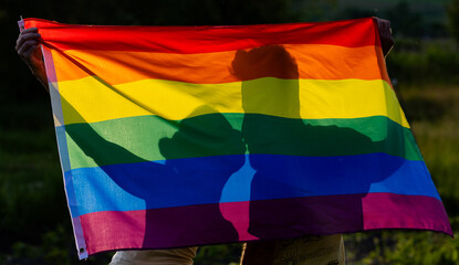 couple holding rainbow flag for pride month