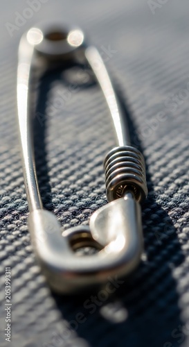 Close-up of a Safety Pin on Fabric Surface.