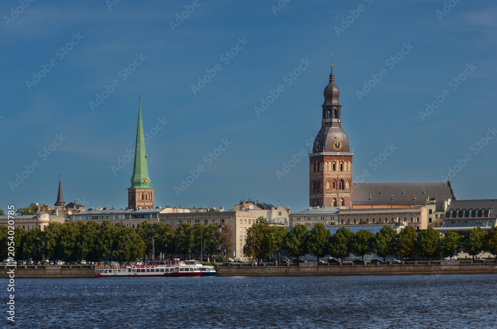 Obraz premium Panorama of Riga Old Town with Daugava River, Dome Cathedral and St. Peter’s Church Spires, Latvia