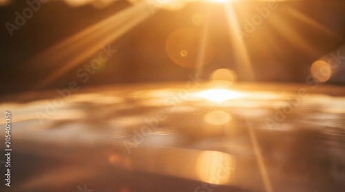 A bright and vibrant sunbeam shines through a darkened landscape with warm golden light