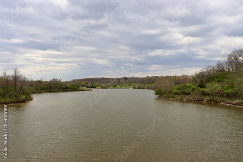 The peaceful lake in the country on a cloudy day.