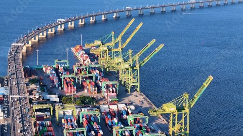 Aerial View of Docks Area Full of Containers in Rio de Janeiro City Port and The Bridge To Niteroi Crossing Guanabara Bay