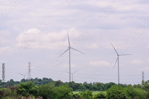 A high-quality photograph of modern wind turbines generating clean renewable energy against a beautiful sky. Symbolizing sustainable development, green technology, environmental conservation, and the 
