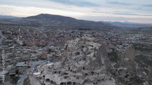 Drone view of Ortahisar Castle towering above the historic town of Ortahisar in Cappadocia, Turkey. A remarkable example of rock-carved architecture.