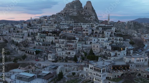 Drone view of Ortahisar Castle towering above the historic town of Ortahisar in Cappadocia, Turkey. A remarkable example of rock-carved architecture.