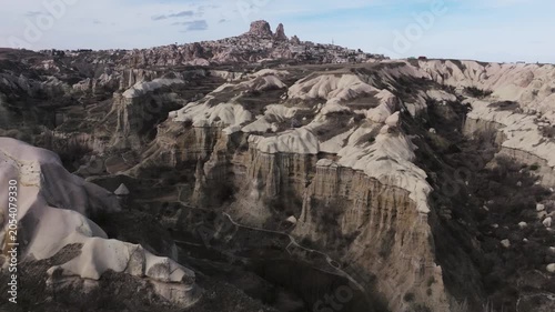 Drone view of Ortahisar Castle towering above the historic town of Ortahisar in Cappadocia, Turkey. A remarkable example of rock-carved architecture.