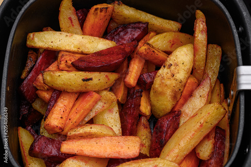 Schilderij op canvas Air fryer dinner, colorful vegetables baked in an air fryer, vegetable fries