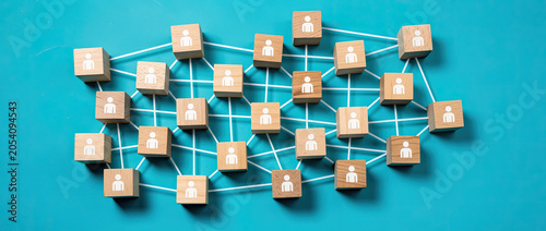 Network of wooden cubes with people icons connected by lines on a blue background.