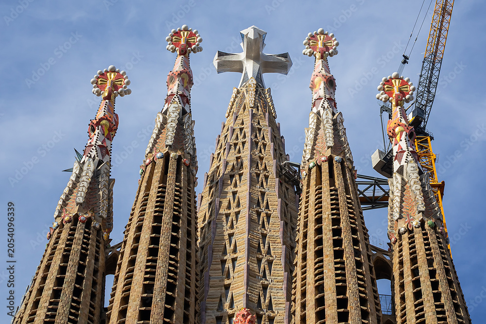Obraz premium La Sagrada Familia - impressive cathedral designed by Gaudi. Tower, dedicated to Jesus Chris with huge three-dimensional four-pointed cross. BARCELONA, SPAIN.