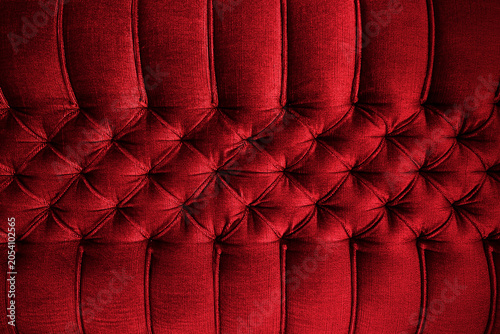 Close-up of red sofa upholstery. Red sofa upholstered with Capitone quilting.