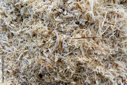 Full frame texture of fresh wooden shavings and sawdust background.