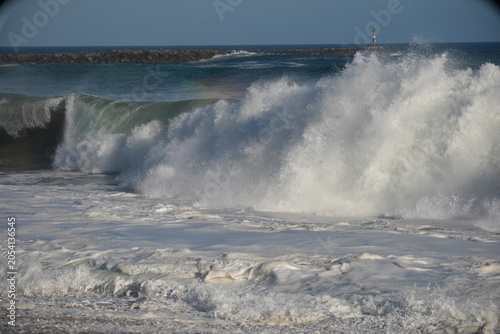 Waves exploding on the sand at the wedge