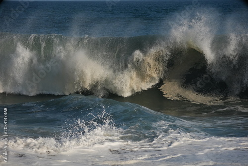 Giant swell barrels breaking at the wedge