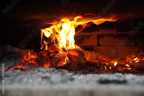 Photos Traditional wood fired stone pizza oven with refractory dome interior, close-up