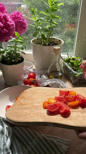 Person slicing fresh cherry tomatoes for a healthy summer salad