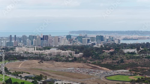 Southern California cityscape featuring San Diego downtown skyline, Balboa Park, Coronado Island peninsula with Pacific Ocean waters visible from above