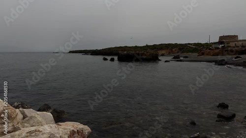 Sea with a dark, rocky horizon