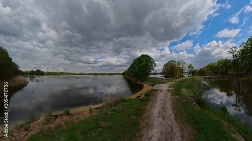 A lake and a country path under an overcast sky