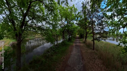 A lake and a country path under an overcast sky