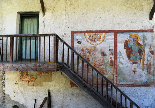 Obraz na plátně Frescoes on the external wall of a characteristic farmhouse in Val di Funes, an