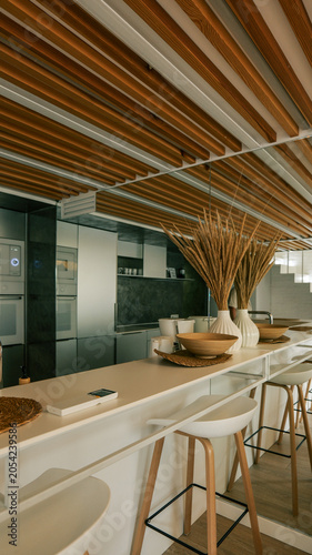 Photography Modern kitchen island with bar stools and decorative dried wheat in vases