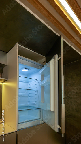 Obraz na płótnie Modern kitchen with an open refrigerator and integrated wooden ceiling details