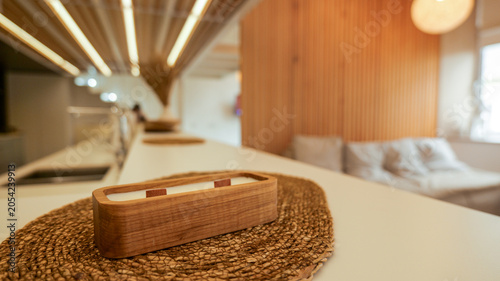 Tableau sur toile Modern wooden candle with double wick on a woven mat in a minimalist interior