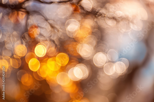 Golden bokeh lights create a dreamy abstract background with warm autumn tones and soft focus. Perfect for seasonal designs, festive projects, and creative visual storytelling