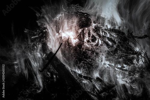 Burning wood logs creating an abstract fire with swirling smoke and glowing embers