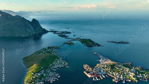 Aerial shot of the ocean meeting the mountains along the beautiful coast of Northern Norway near the town of Reine