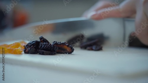 Cutting dried fruits on cutting board