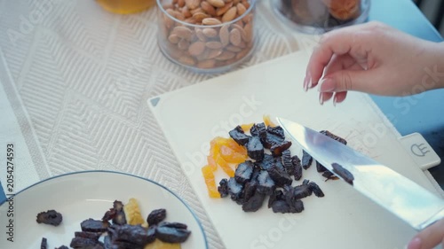 Top view of slicing dried apricots and prunes for traditional Armenian dish