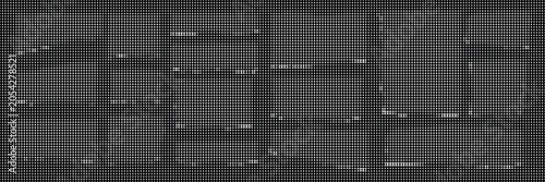 A close-up view of a dark gray brick wall with white grout lines