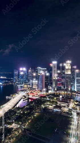 Time lapse of Marina Bay and the Singapore skyline at night. Vertical Video.