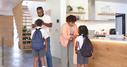 African American family at entry getting kids ready for school parents checking backpacks hugging
