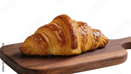 Photography Golden brown flaky croissant pastry on a dark wooden cutting board, isolated on