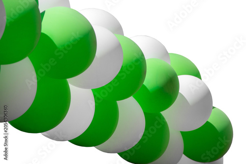 Green and white balloons arranged in a decorative arch formation